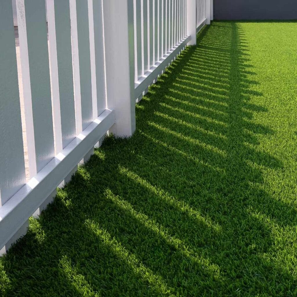 Example of a Residential artificial grass with a white PVC fence